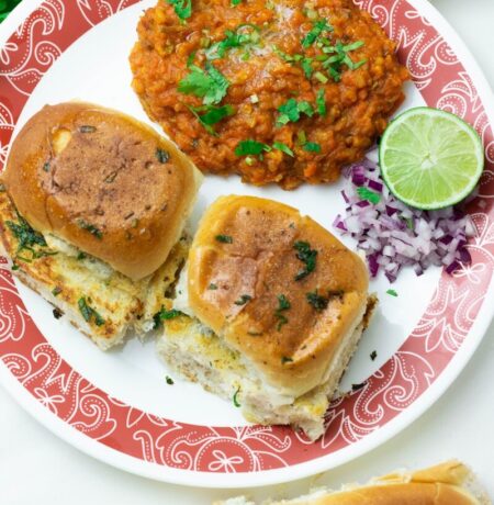 a red and white plate topped with sandwiches and other food